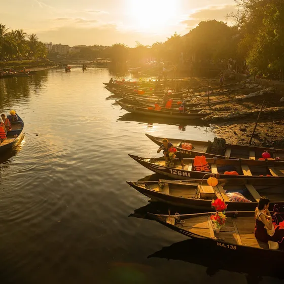 Wooden boats on the river at sunset in Hoi An, Vietnam